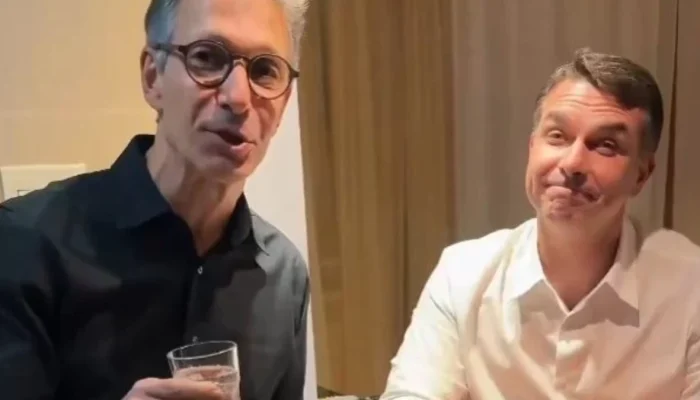 Na gravação, Zema e Flávio aparecem lado a lado, segurando copos de água — Foto: